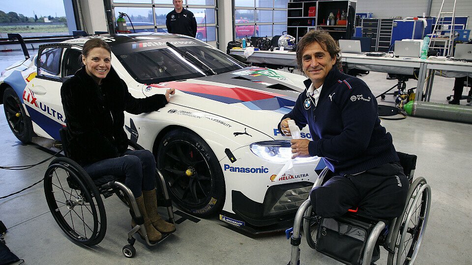 Alex Zanardi mit Besucherin und Rennfahrerin Nathalie McGloin, Foto: BMW Motorsport